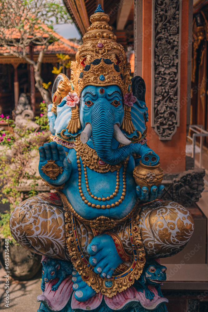 Fototapeta premium Sculpture of blue Lord Ganesha in balinese temple. Indonesian hindu god, symbol of happiness and wisdom