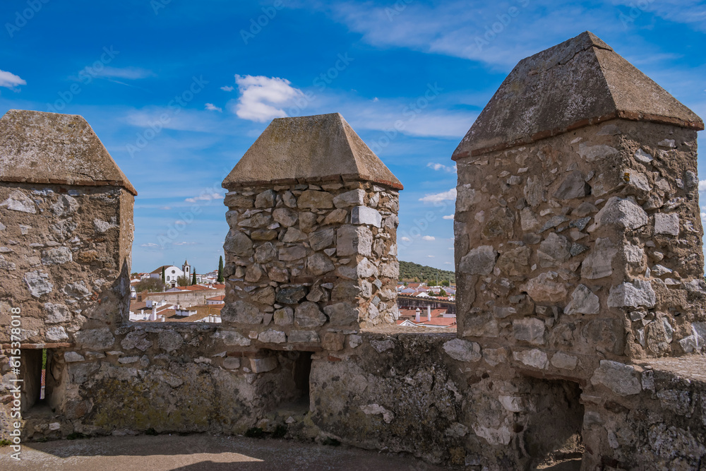 Stone walls of Serpa castle with church in background, Alentejo PORTUGAL Stone walls of Serpa castle with church in background, Alentejo PORTUGAL