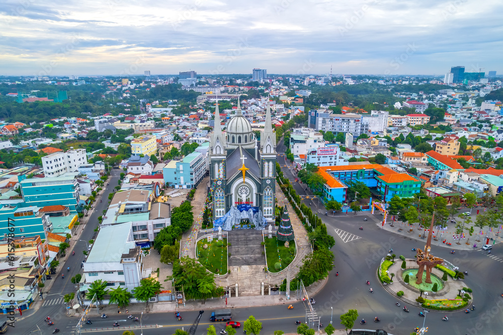 Aerial view of Thu Dau Mot cityscape at morning with church on hill in center. Urban development texture, transport infrastructure and green parks along Be River in Southeast region of Vietnam