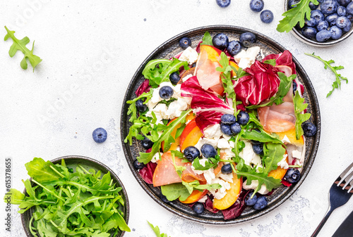 Slika na platnu Gourmet fresh salad with arugula, radicchio, sweet peaches, ham, cheese and blueberries