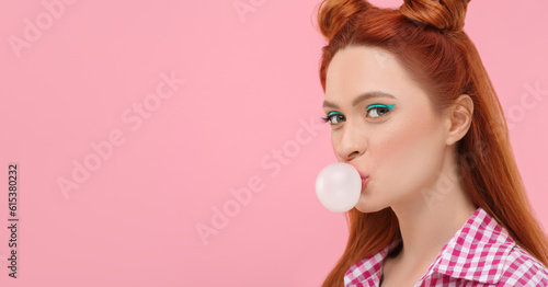 Beautiful woman with bright makeup blowing bubble gum on pink background. Space for text © New Africa