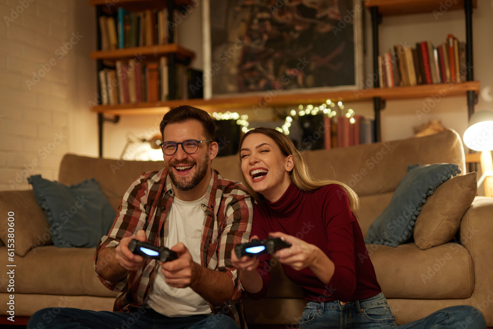 Young couple having fun at home playing video games Young couple having fun at home playing video games