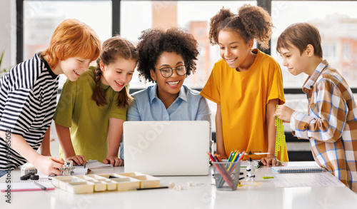 Teacher and students watching laptop screen