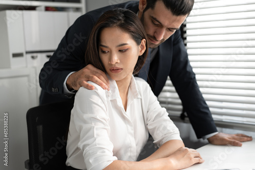 Sexual harassment at workplace concept. Attractive Asia woman being molested by caucasian businessman at office © chachamp