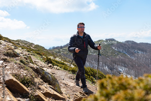Man hiking on a mountain trail. Montseny mountains, Catalonia, Spain. photo