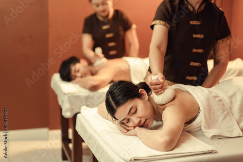Photos Relaxation Asian woman customer get service Thai herbal compress massage in beauty spa centre