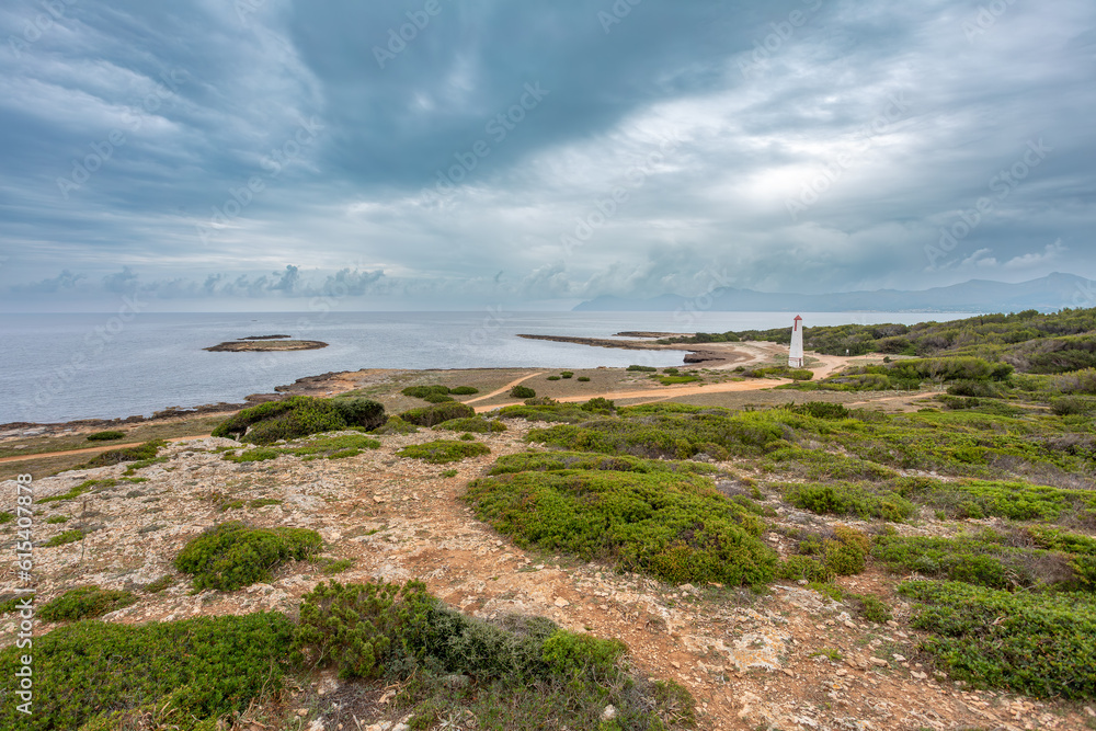 Natural beach near city Can Picafort with small Lighthouse in background. Balearic Islands Mallorca Spain. Travel agency vacation concept.