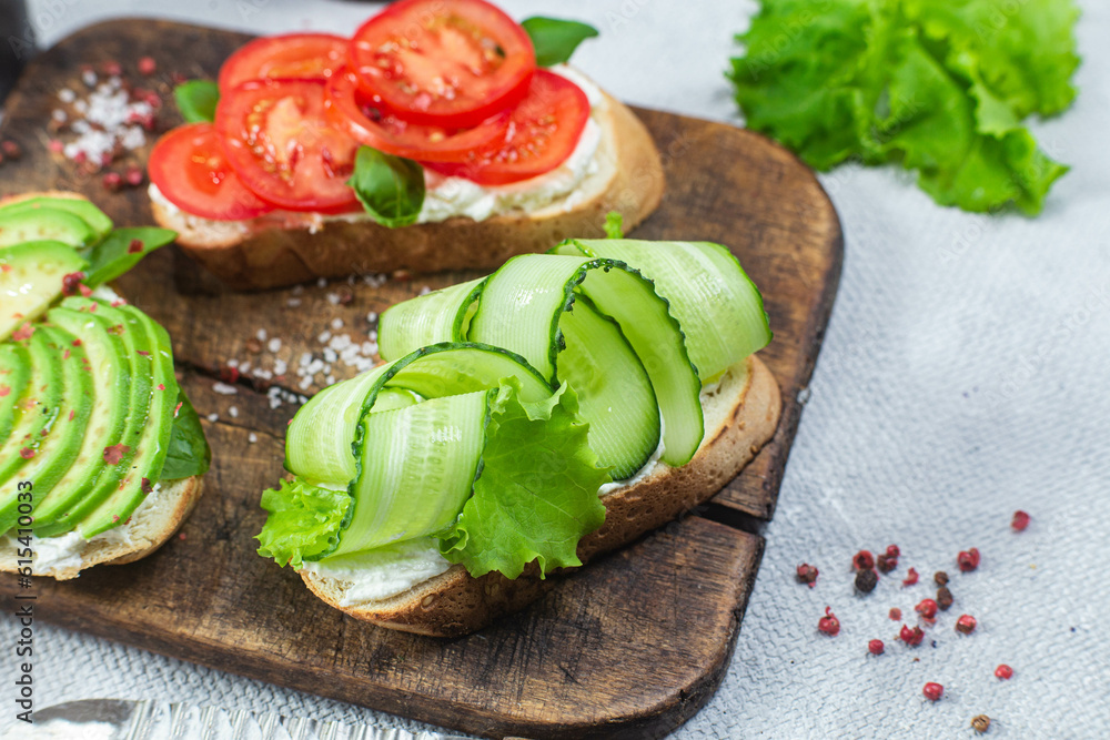 Sandwiches with tomato, avocado and cucumber Sandwiches with tomato, avocado and cucumber