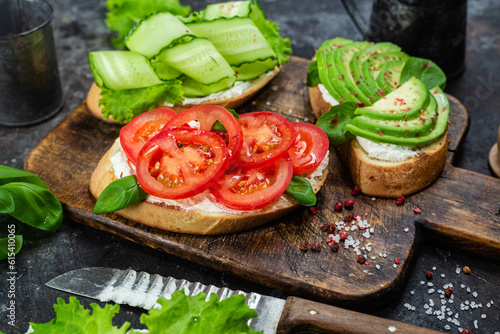 Sandwiches with tomato, avocado and cucumber