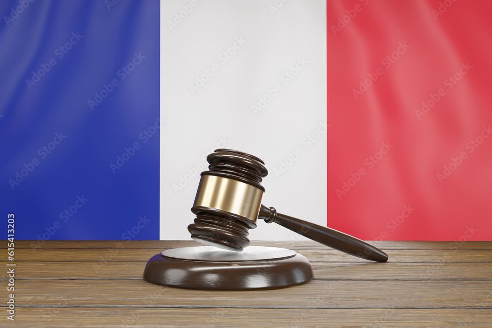 Small hammer gavel of judges of courts placed on a wooden table with the national flag of France as background. Illustration of the concept of French legal system and judicial issues