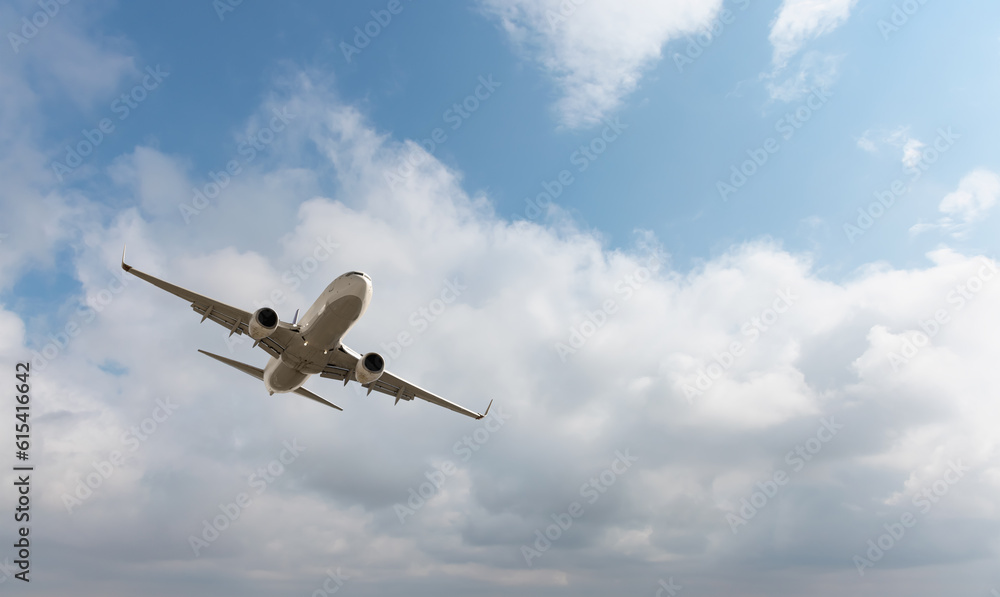White passenger airplane flying in the sky amazing clouds in the background - Travel by air transport White passenger airplane flying in the sky amazing clouds in the background - Travel by air transport