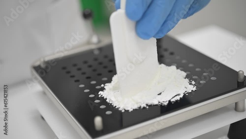 Pharmacist filling capsule filler with medical powder using spatula