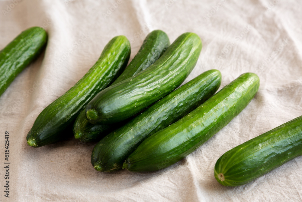 Organic Mini Baby Cucumbers on a white wooden background, low angle view. Organic Mini Baby Cucumbers on a white wooden background, low angle view.