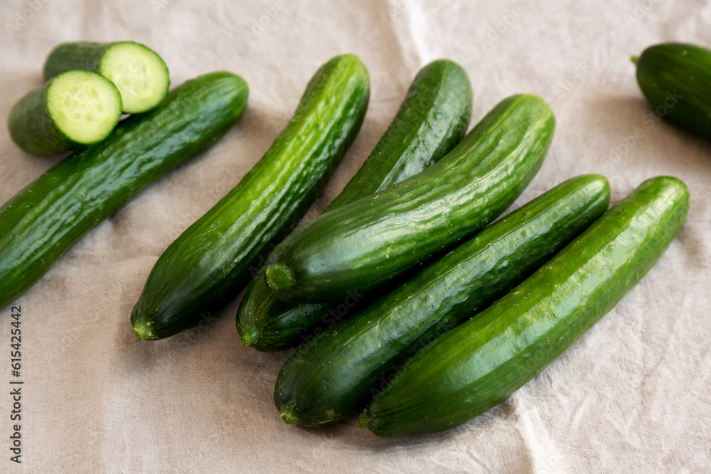 Organic Mini Baby Cucumbers on a white wooden background, side view. Organic Mini Baby Cucumbers on a white wooden background, side view.