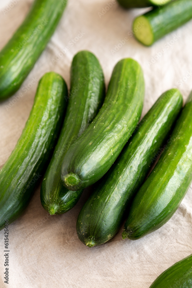 Organic Mini Baby Cucumbers on a white wooden background, side view. Organic Mini Baby Cucumbers on a white wooden background, side view.
