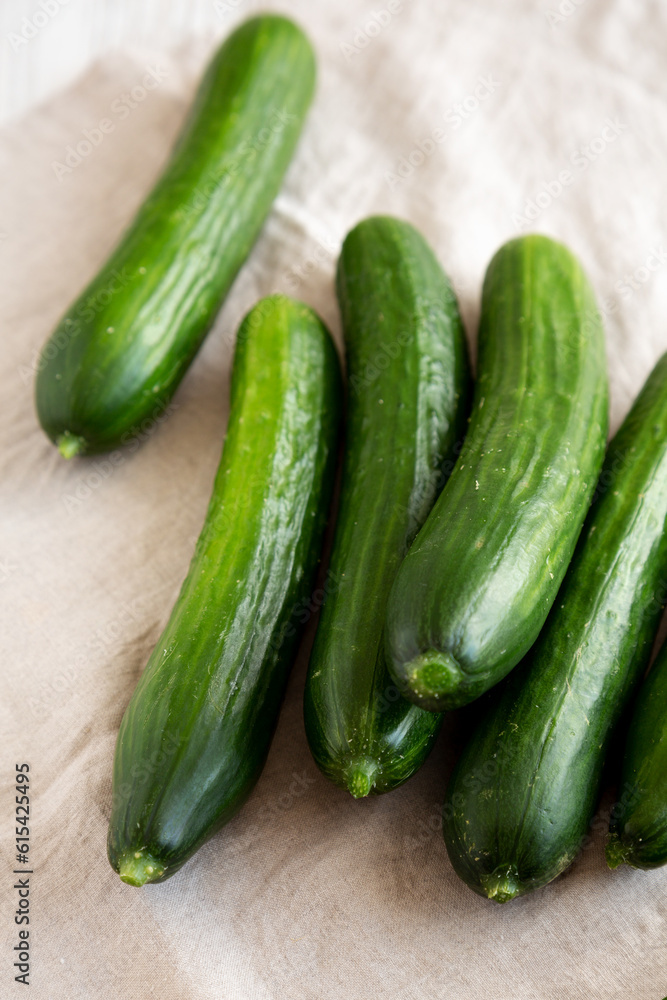 Organic Mini Baby Cucumbers on a white wooden background, side view. Organic Mini Baby Cucumbers on a white wooden background, side view.