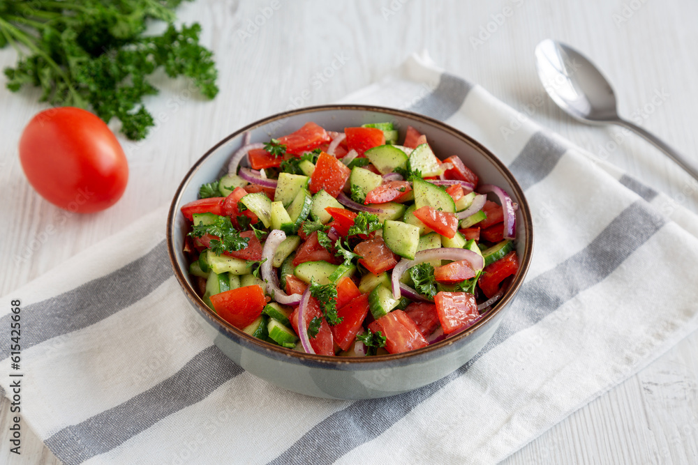 Homemade Mediterranean Cucumber Tomato Salad in a Bowl, side view. Homemade Mediterranean Cucumber Tomato Salad in a Bowl, side view.