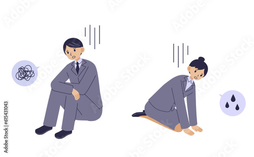落ち込んで座り込むスーツ姿の男女