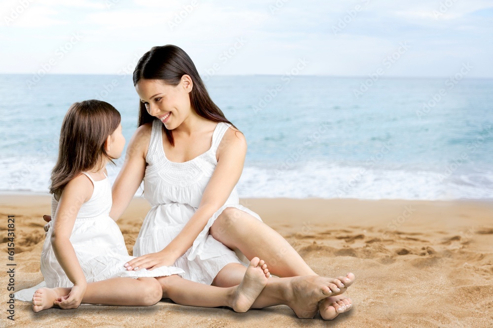 Smiling mother and daughter having fun on sea background Smiling mother and daughter having fun on sea background