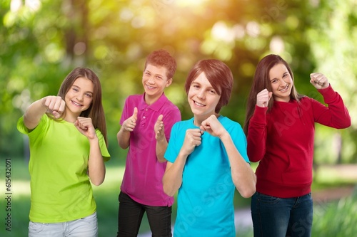 Happy, cute kids in a park background playing together