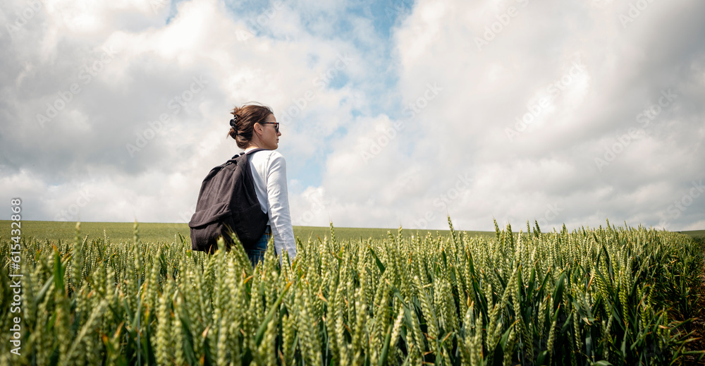 Woman walking through wheat field, getting away from it all. Woman walking through wheat field, getting away from it all.