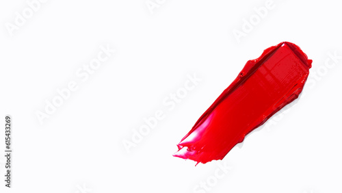 Smear and texture of lipstick or acrylic paint isolated on white background. Cream makeup texture. Bright red color cosmetic product brush stroke swipe sample