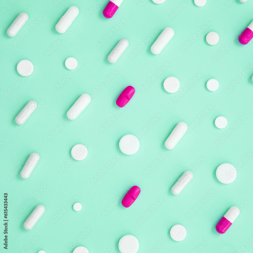 Various colorful medication tablets and capsules on green background. Concept of healthcare and medicine. Top view, pattern Various colorful medication tablets and capsules on green background. Concept of healthcare and medicine. Top view, pattern