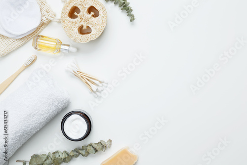 Natural organic eco cosmetics. Soap Eco, reusable cotton pads, loofah natural sponge washcloth, cotton swab, eucalyptus leaves, towel on white background. Flat lay, top view, copy space