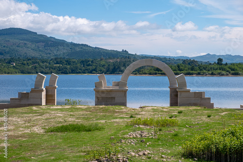 Roman ruins with lake. Aquis Querquennis archaeological site, arched stone door. Baños de Bande, Orense, Spain. photo