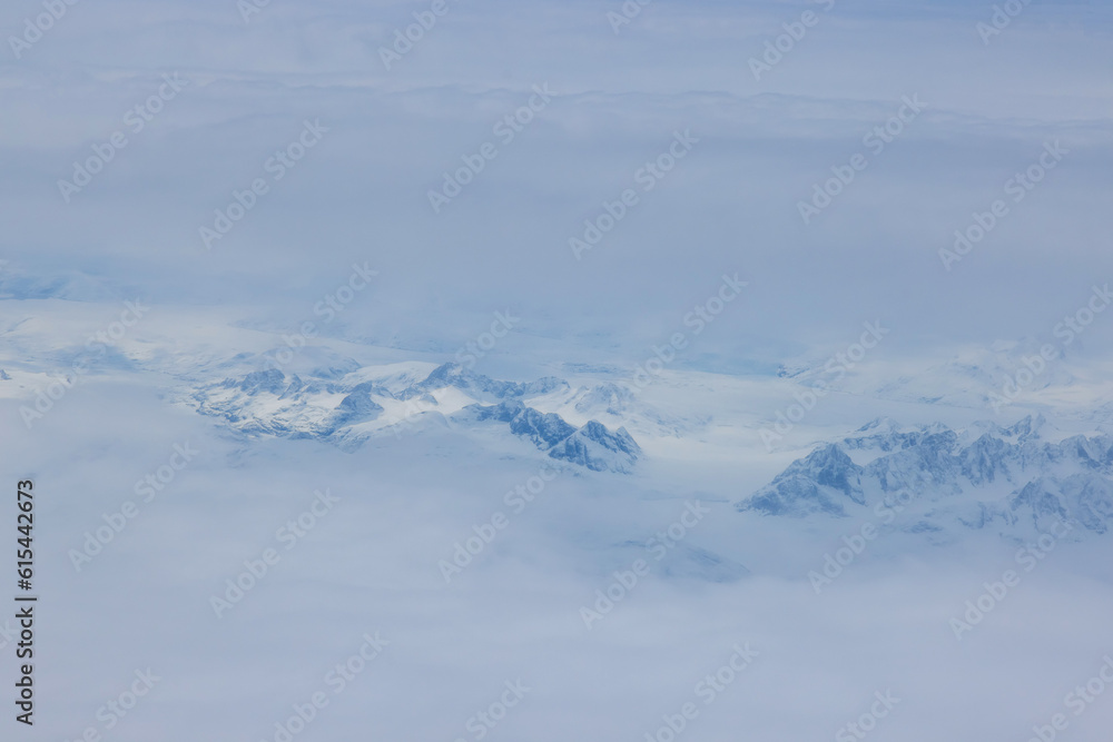 Clouds add mystical touch to already beautiful Greenland mountain peaks, creating an enchanting landscape
