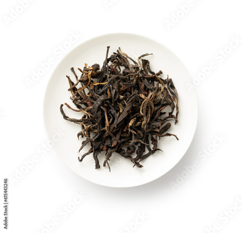 Tea sample in white dish. Black tea sample. Tea leaves on white background.