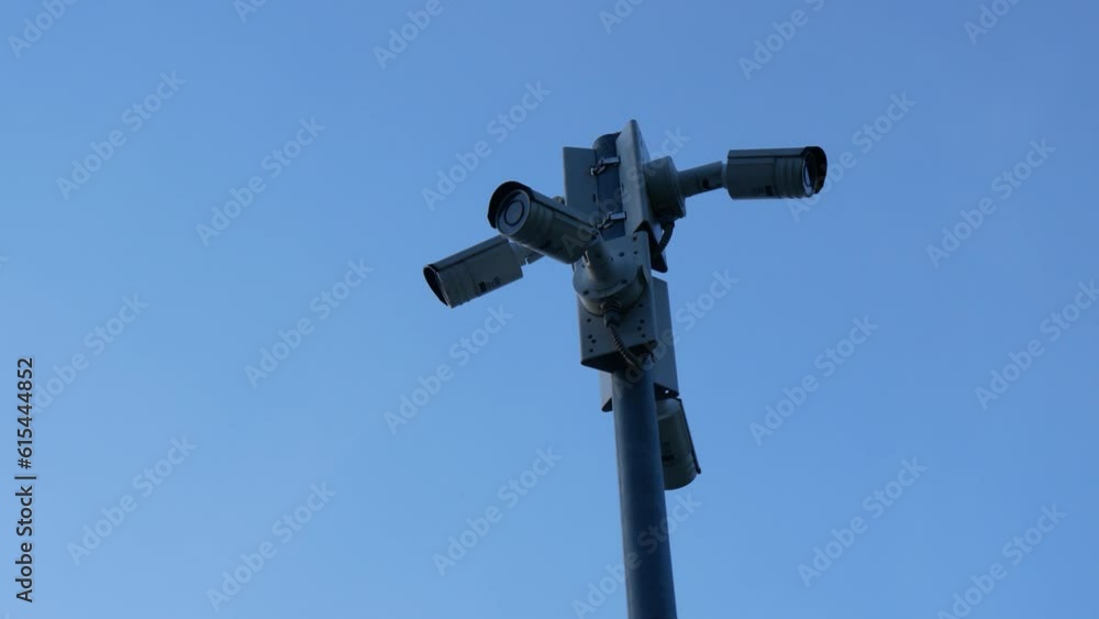 A Pole With Street Surveillance Cameras on the Background of the Sky A Pole With Street Surveillance Cameras on the Background of the Sky