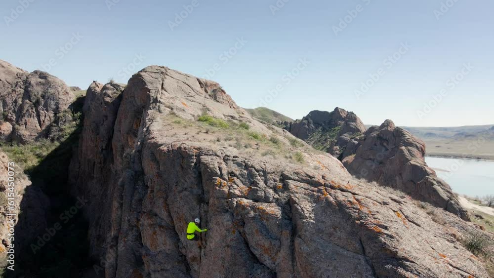 Man athlette climbing on the high rock Man athlette climbing on the high rock