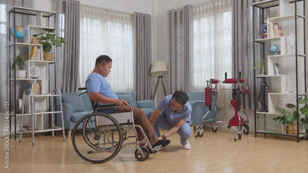 Full Body Side View Of Asian Male Nurse Helping A Patient In Wheelchair Putting Feet On Footrest And Pushing Him To Another Room After A Physical Therapy At Home
Full Body Side View Of Asian Male Nurse Helping A Patient In Wheelchair Putting Feet On Footrest And Pushing Him To Another Room After A Physical Therapy At Home
