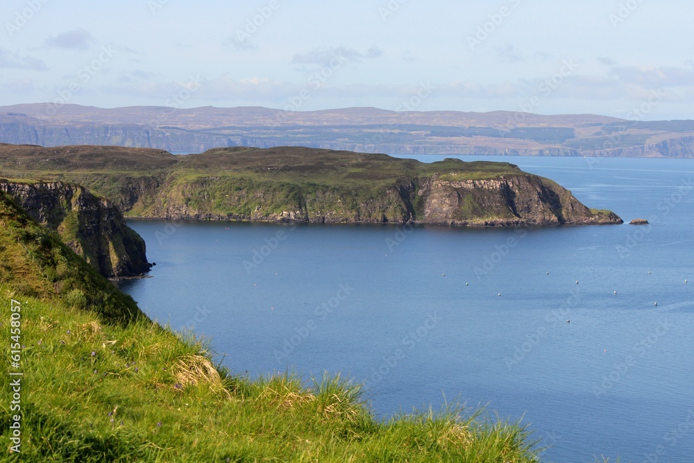 A spectacular view of the Isle of Skye and its rugged coastline of cliffs on a sunny blue sky summer day