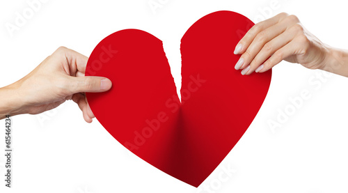 Male and female hands tearing a red heart symbol of love in half, cut out photo