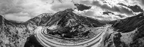 Highway Interstate 70 curves through a mountainous landscape under a cloudy sky in Colorado, USA; United States of America photo