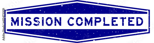 Grunge blue mission completed word hexagon rubber seal stamp on white background