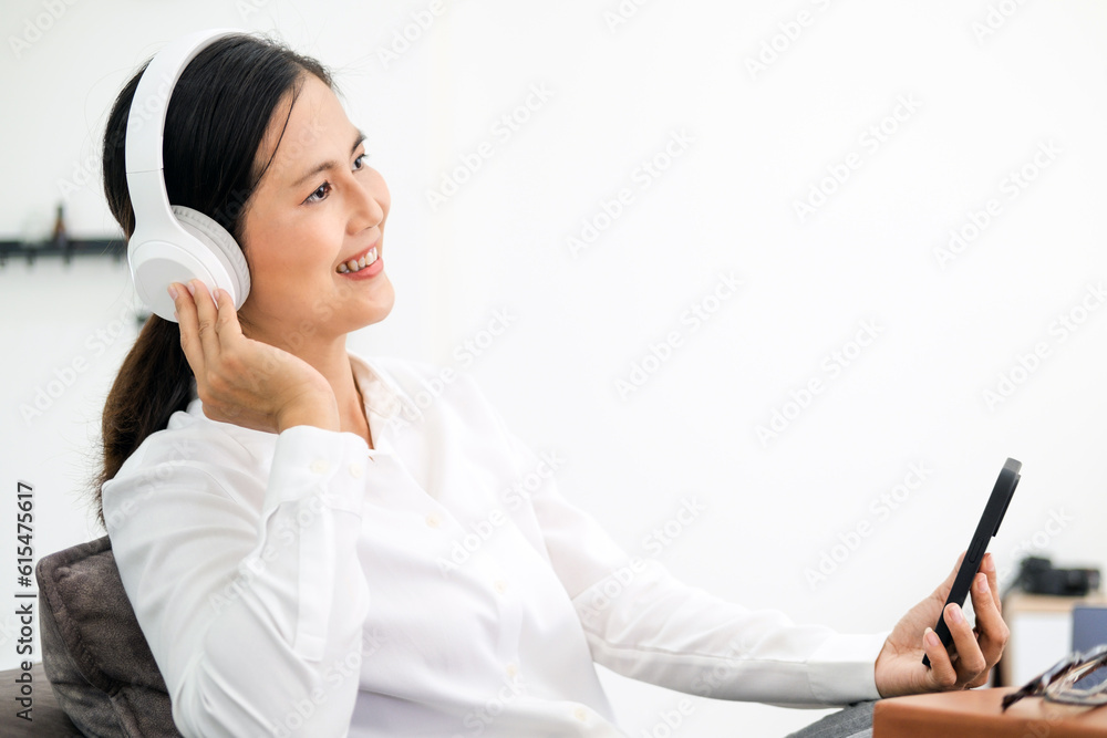 closeup photo of beautiful woman wearing stylish casual outfit isolated over colorful background wall wearing white wireless headphones and listening to music and using mobile phone closeup photo of beautiful woman wearing stylish casual outfit isolated over colorful background wall wearing white wireless headphones and listening to music and using mobile phone