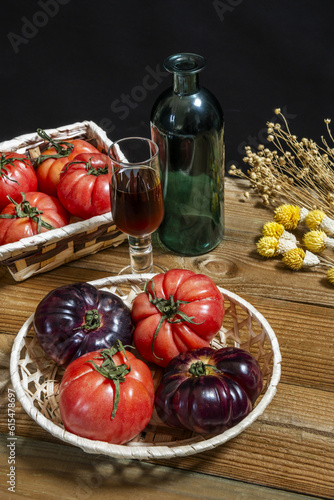 A still life of delicious ripe tomatoes inside baskets