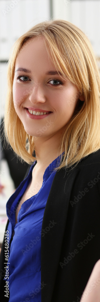 Beautiful smiling woman in workplace with a group of colleagues in background. Business consultant manager businesswoman and successful career in business Beautiful smiling woman in workplace with a group of colleagues in background. Business consultant manager businesswoman and successful career in business