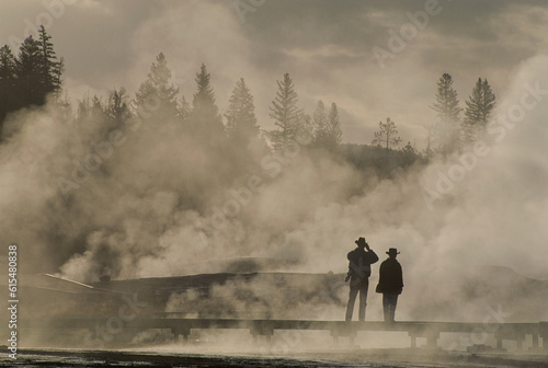 Tourists in geothermal steam and fog near the Upper Geyser Basin, Yellowstone National Park, USA; Wyoming, United States of America photo