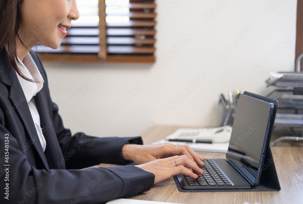 Side view and close up of woman hands typing on laptop keyboard placed on wooden office desktop with supplies. Technology concept Side view and close up of woman hands typing on laptop keyboard placed on wooden office desktop with supplies. Technology concept