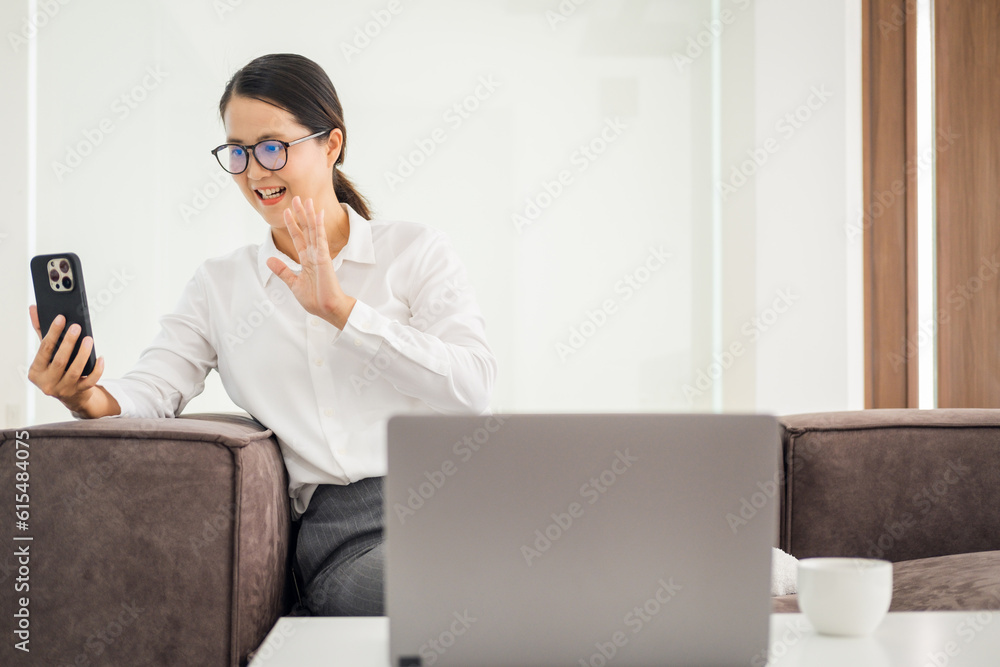 Happy mature asian woman waving hand using smartphone app enjoying online virtual chat video call with friends in distance mobile chat virtual meeting, recording stories for social media at home. Happy mature asian woman waving hand using smartphone app enjoying online virtual chat video call with friends in distance mobile chat virtual meeting, recording stories for social media at home.