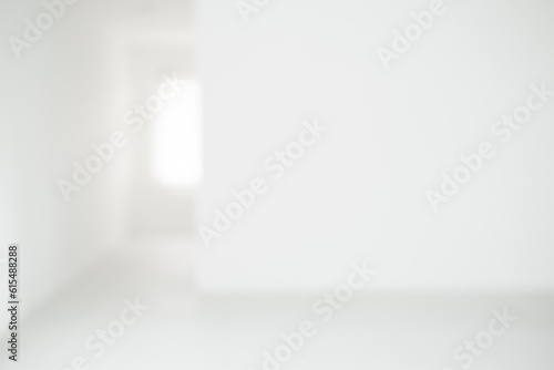 Empty blur white corridor hallway of modern white office building.Abstract white studio background for product presentation. Empty gray room with shadows of window. Display product blurred backdrop.