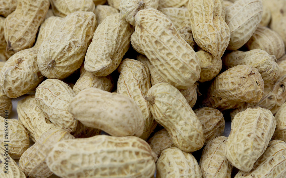 Bunch peanuts on a white background close-up. Macro photography of peanuts. Bunch peanuts on a white background close-up. Macro photography of peanuts.