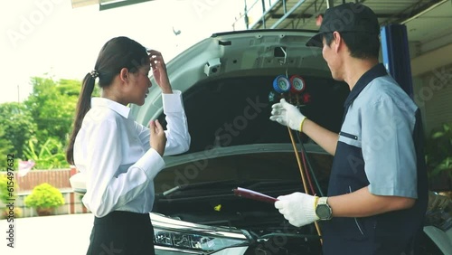 Male auto mechanic skillfully inspects car air conditioning cooling system of female customer service to repair damage and refrigerant leak while driving a vehicle in hot weather.