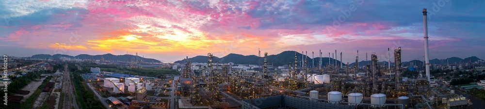 Fototapeta premium Crude Oil Refinery Plant Steel Pipe line and Chimney and Cooling tower, Chemical or Petrochemical factory plant power plant, Petrochemical tower tank industry at sunset