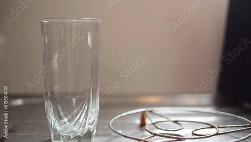 Pouring tender coconut in a transparent glass cup. It shows the purity of coconut water with its helath benefits during summer