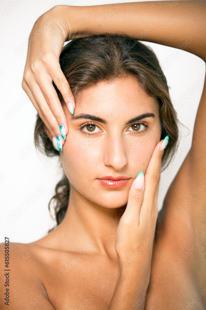Confident woman touching face with painted fingernails. Confident woman touching face with painted fingernails.